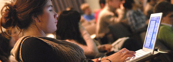An engineering student takes notes during a lecture.