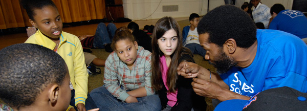 Instructor Cyril Hodge offers guidance during the "Eggs Away!" workshop at Siemens Science Day at Columbia University. Clockwise from left: Khalil, Amber, Ashley, Orien and Tyler.